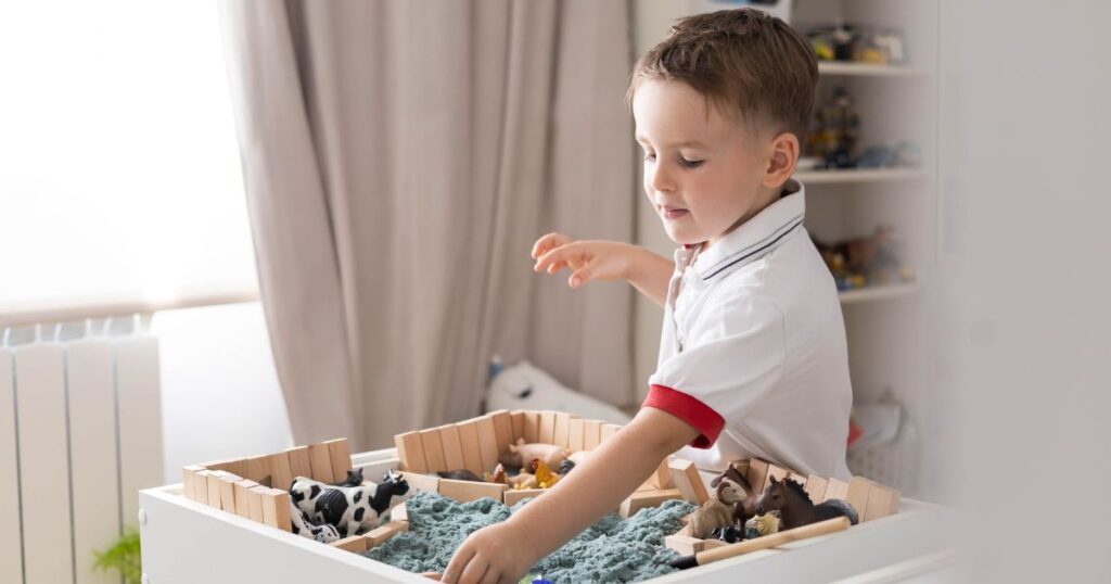 toddler playing with sensory tub